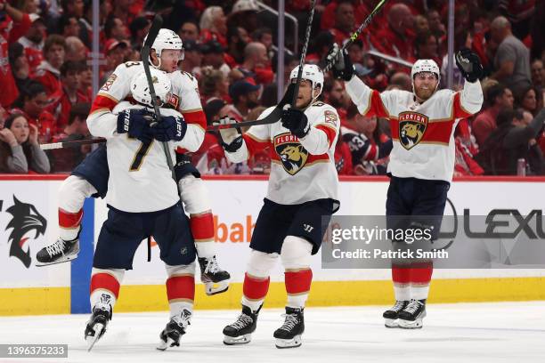 Carter Verhaeghe of the Florida Panthers celebrates with teammates after scoring the game-winning goal against the Washington Capitals during...