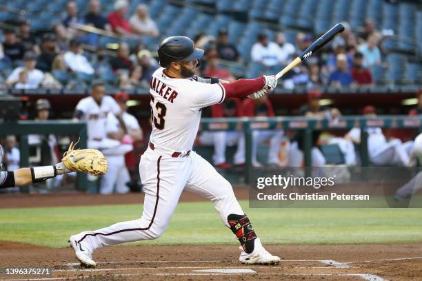 Christian Walker of the Arizona Diamondbacks hits a two-RBI double against the Miami Marlins during the first inning of the MLB game at Chase Field...