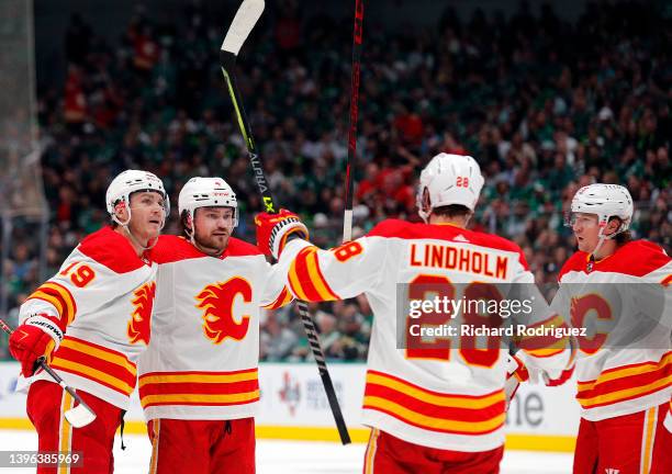 Matthew Tkachuk, Rasmus Andersson, Elias Lindholm, and Tyler Toffoli of the Calgary Flames celebrate a second period goal against the Dallas Stars in...