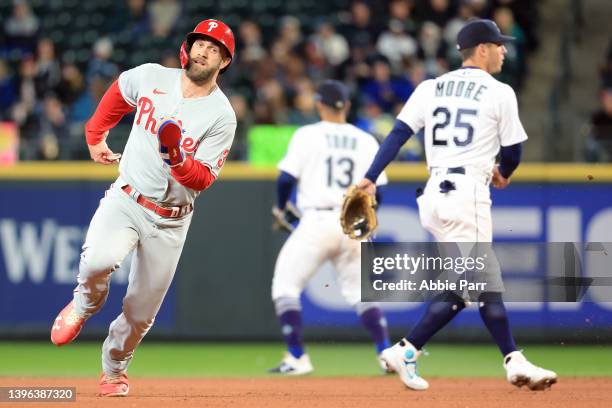 Bryce Harper of the Philadelphia Phillies advances to third base after a double hit by Nick Castellanos against the Seattle Mariners during the fifth...