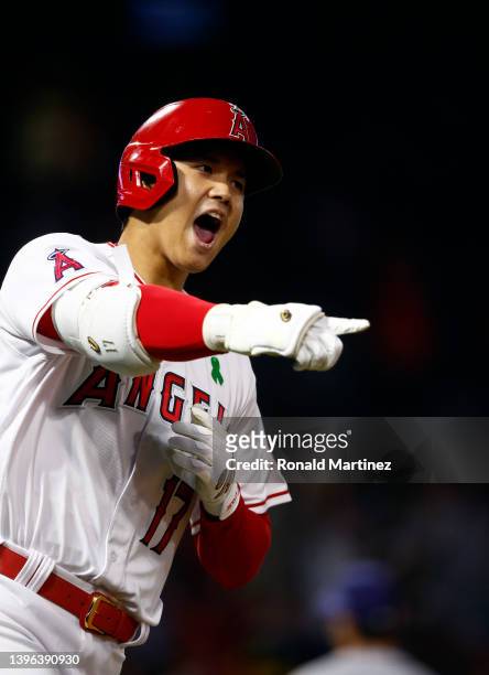 Shohei Ohtani of the Los Angeles Angels celebrates after hitting a grand slam against the Tampa Bay Rays in the seventh inning at Angel Stadium of...