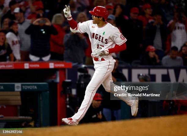 Shohei Ohtani of the Los Angeles Angels celebrates after hitting a grand slam against the Tampa Bay Rays in the seventh inning at Angel Stadium of...