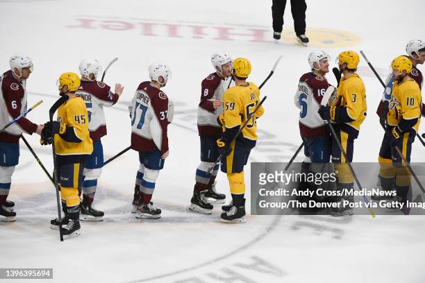 The Colorado Avalanche and the Nashville Predators line up and shake hands after the Avalanche won game four of the first round of the Stanley Cup...