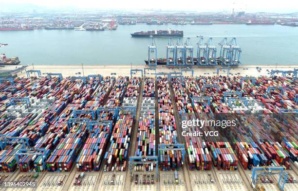 Aerial view of shipping containers sitting stacked at Asia's first fully automated container terminal of Qingdao Port on May 9, 2022 in Qingdao,...