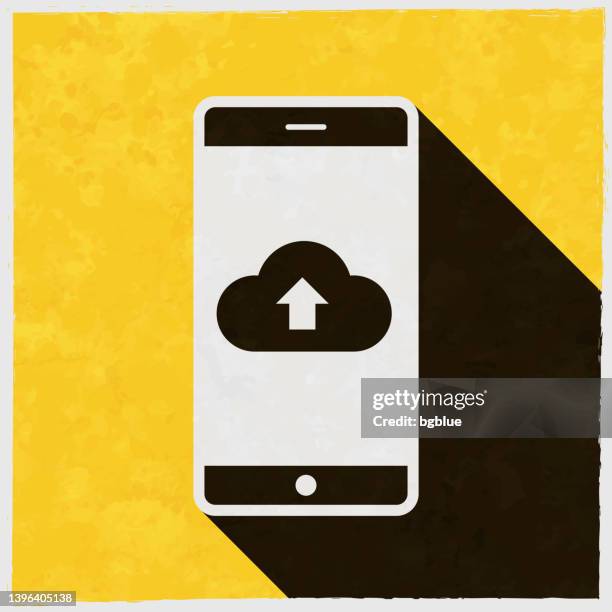 cloud upload from smartphone. icon with long shadow on textured yellow background - phone screen texture stock illustrations
