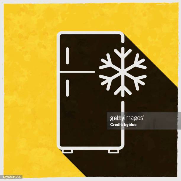 kühlschrank mit schneeflocke. symbol mit langem schatten auf strukturiertem gelbem hintergrund - freezer icon stock-grafiken, -clipart, -cartoons und -symbole