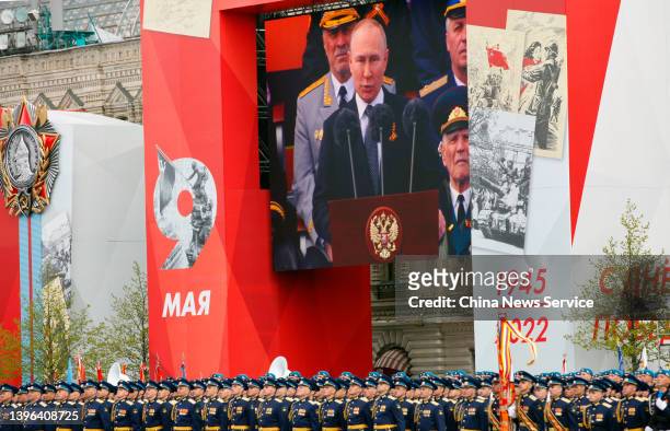 Russian President Vladimir Putin is seen on the screen as he speaks during the Victory Day military parade at Red Square on May 9, 2022 in Moscow,...