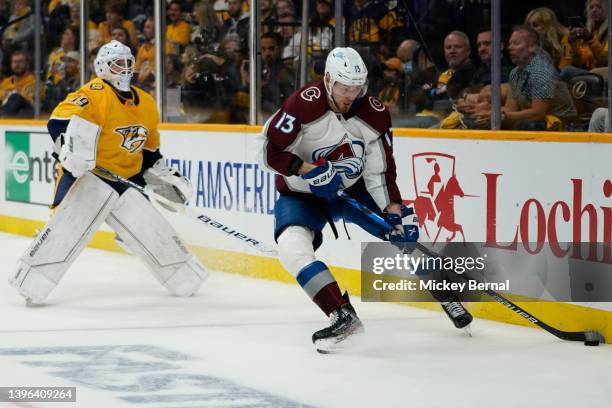 Valeri Nichushkin of the Colorado Avalanche works the puck behind the net of Connor Ingram of the Nashville Predators during the second period of...