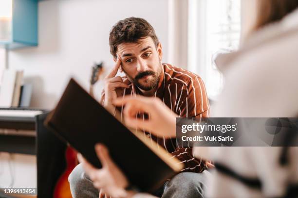 employee confused in a meeting - frowning stock pictures, royalty-free photos & images