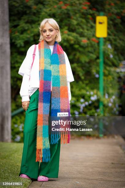 Kika Lateef wearing ACNE studio scarf, green Camilla and Marc pants and Crocs shoes at Afterpay Australian Fashion Week 2022 on May 10, 2022 in...