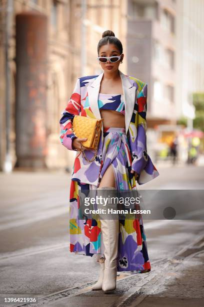 Piyane Ung wearing Cambodian designer Kong LABEL and Louis Vuitton yellow clutch at Afterpay Australian Fashion Week 2022 on May 10, 2022 in Sydney,...