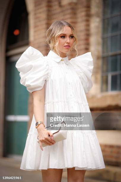 Katrina West wearing Louis Vuitton earrings, Aje dress and Burberry clutch at Afterpay Australian Fashion Week 2022 on May 10, 2022 in Sydney,...