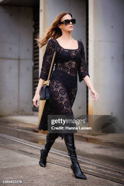 Erin Holland is seen wearing We Are Kindred black lace dress, Chanel sunglasses, Chanel bag and knee high black boots at Afterpay Australian Fashion...