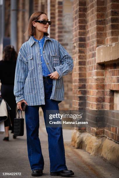 Jess Alizzi wearing miu miu jacket and bag , the vermin shirt and St Agni jeans and Louis Vuitton shoes at Afterpay Australian Fashion Week 2022 on...