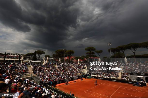 General view over court Pietrangeli as Nikoloz Bailashvili of Georgia serves in his men's singles first round match against Dan Evans of Great...