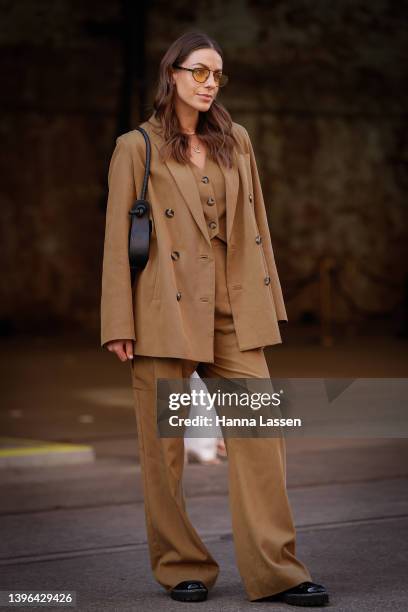 Ash Gratsounas wearing Shona joy suit, Brie leon bag, Jo mercer shoes and Lu goldie sunglasses at Afterpay Australian Fashion Week 2022 on May 10,...