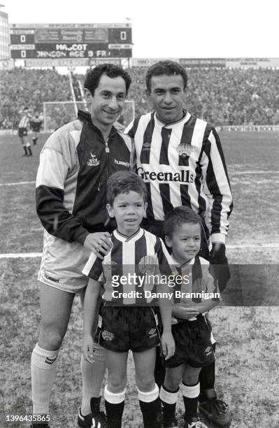 Argentina and Tottenham player Ossie Ardiles pictured with Brazil and Newcastle striker Mirandinha and his sons as the snow comes down before a First...