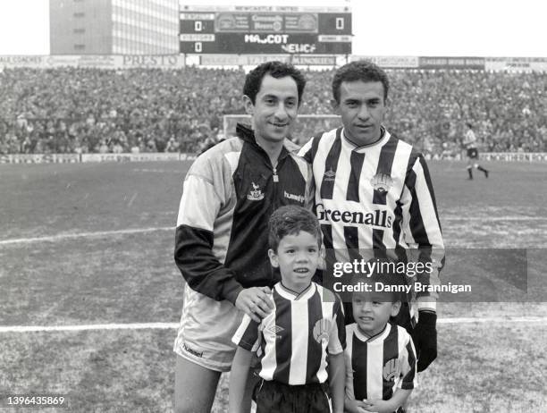Argentina and Tottenham player Ossie Ardiles pictured with Brazil and Newcastle striker Mirandinha and his sons as the snow comes down before a First...