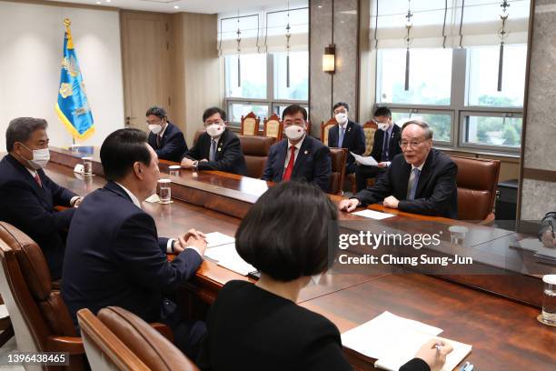 South Korean President Yoon Suk-Yeol talks with Chinese Vice President Wang Qishan, after his inauguration ceremony at the new presidential office on...