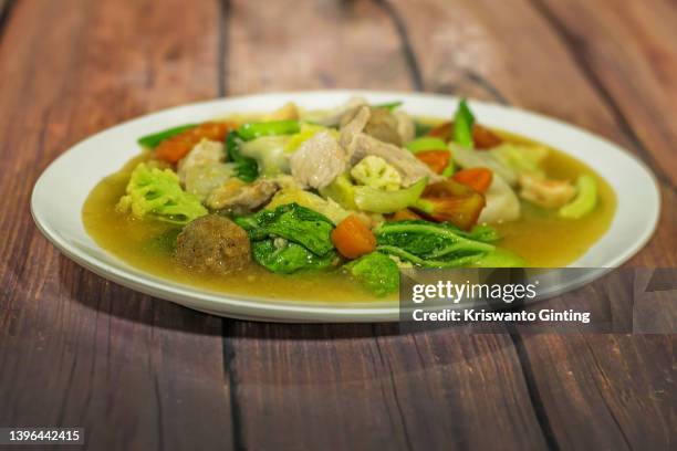 chinese indonesian cuisine is characterized by the mixture of chinese with local indonesian style on wood table. - boiled vegetables stock pictures, royalty-free photos & images