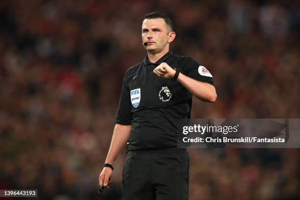 Referee Michael Oliver gestures during the Premier League match between Liverpool and Tottenham Hotspur at Anfield on May 07, 2022 in Liverpool,...
