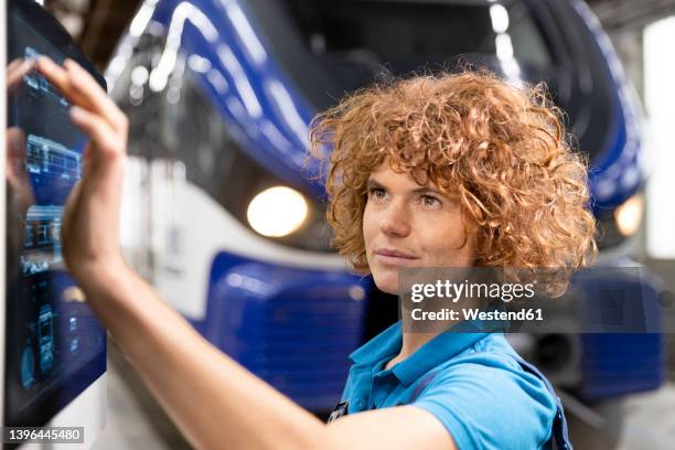 engineer using touch screen device in factory - rail engineer stock pictures, royalty-free photos & images