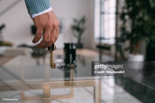 man with house keys at home - returning keys stock pictures, royalty-free photos & images