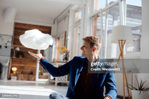 happy businessman looking at levitating cloud network sitting in office - lightweight stock pictures, royalty-free photos & images