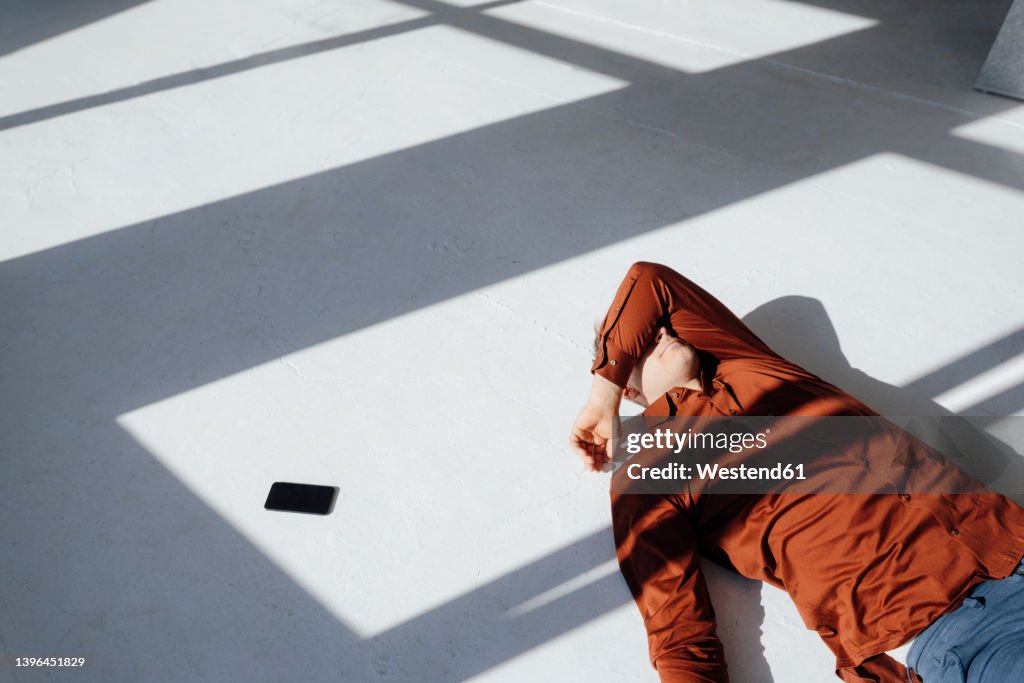 Businessman resting on floor in office