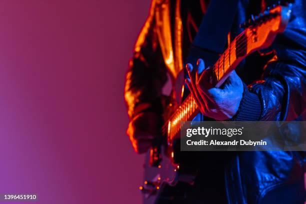 musician guitarist plays music on the guitar for a performance. man with musical instrument. advertisement - vocal guitar stock-fotos und bilder