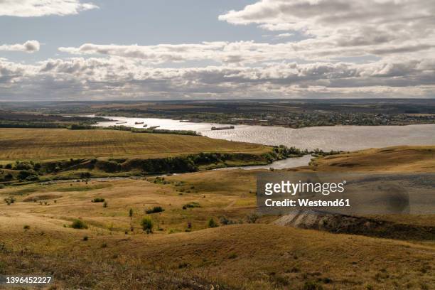 scenic view of volga river under cloudy sky - volga river stock pictures, royalty-free photos & images