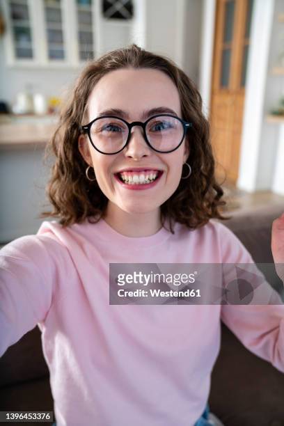 cheerful woman with eyeglasses at home - selfies stockfoto's en -beelden