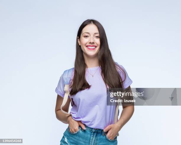 happy woman in t-shirt wearing backpack - female bush photos stock pictures, royalty-free photos & images