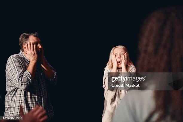 male and female stage performers practicing emotions together in class - acting fotografías e imágenes de stock