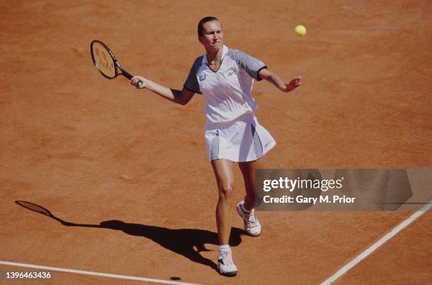 Iva Majoli from Croatia plays a forehand return to Martina Hingis of Switzerland during their Women's Singles Final match at the French Open Tennis...