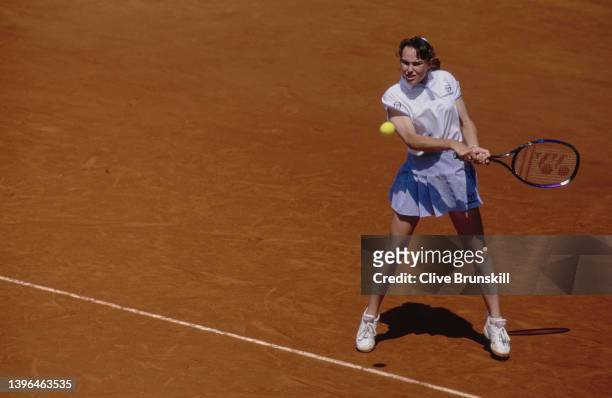 Martina Hingis of Switzerland plays a double handed forehand return to Lindsay Davenport of the United States during their Women's Singles Third...