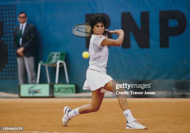 Gabriela Sabatini from Argentina plays a backhand return against Chris Evert Lloyd of the United States during their Women's Singles Fourth Round...