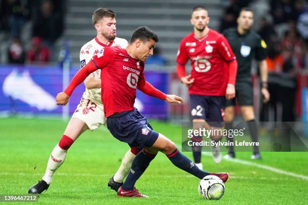 Caio Henrique Oliveira Silva of AS Monaco competes for the ball with Benjamin Andre of Lille OSC during the Ligue 1 Uber Eats match between Lille OSC...