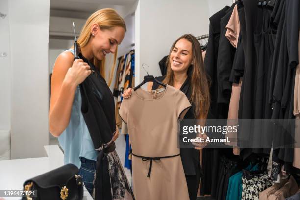 young women on a shopping spree - fashion stylist stock pictures, royalty-free photos & images