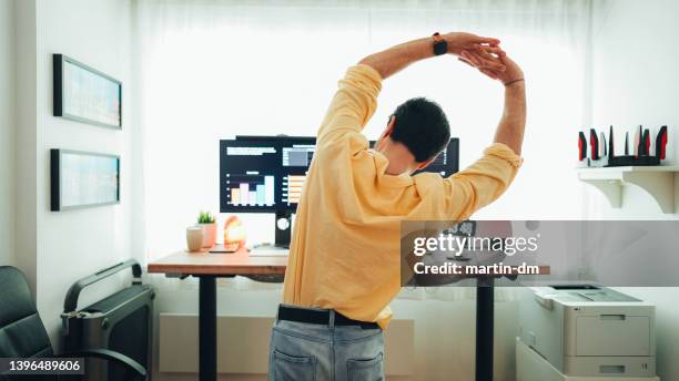 man working at standing desk - stretcha bildbanksfoton och bilder