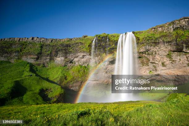 seljalandsfoss waterfall against the sunlight, south iceland - セリャランスフォス ストックフォトと画像