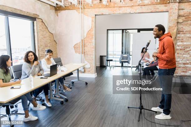 young adult man smiling as he prepares to recite lines - audition bildbanksfoton och bilder