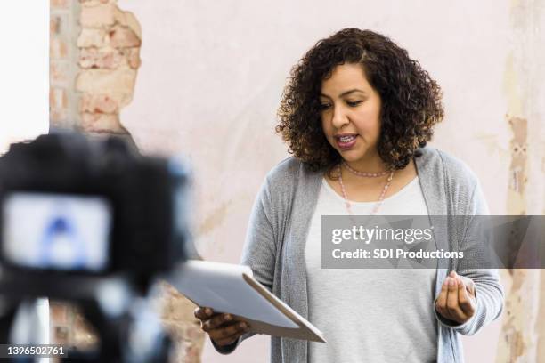 young adult woman stands in front of the camera to audition - audition stockfoto's en -beelden