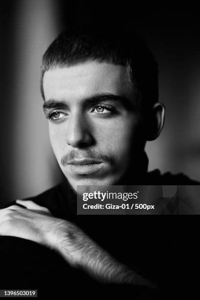 close-up of thoughtful young man looking away - black and white portrait man stock pictures, royalty-free photos & images