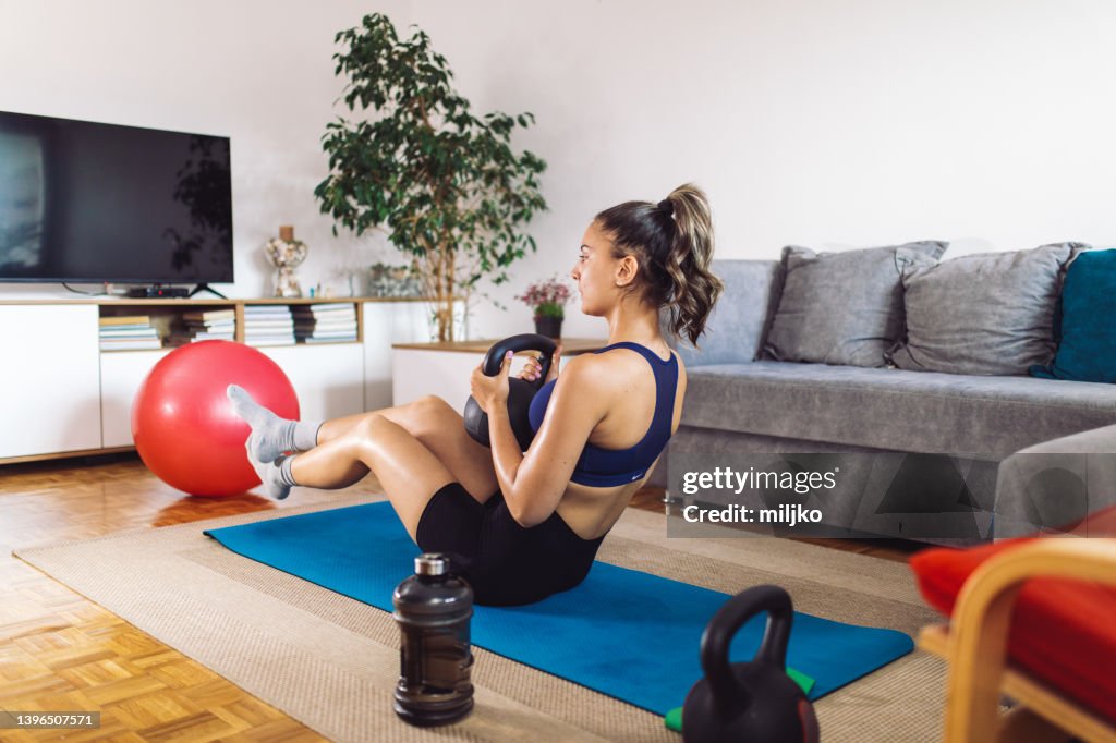 Young woman doing fitness workout training at home