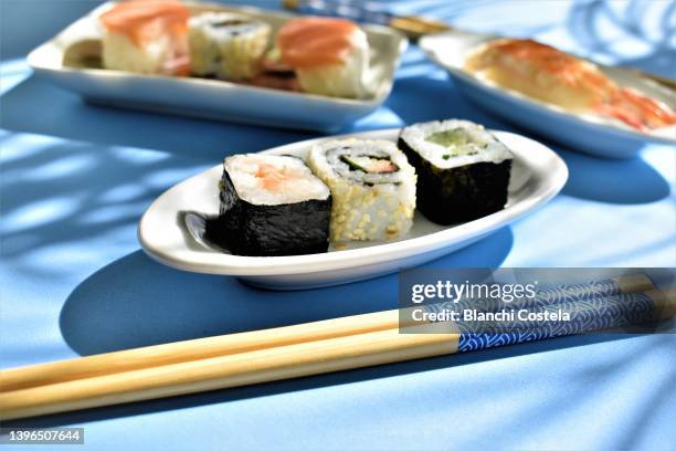 sushi variety on blue background - maki sushi ストックフォトと画像