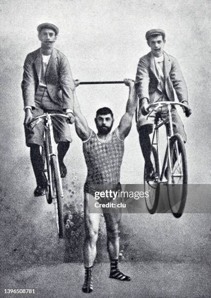 stockillustraties, clipart, cartoons en iconen met hercules georg stangelmaier holds up two men seated on bicycles - sports archive