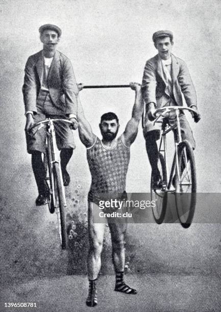 hercules georg stangelmaier holds up two men seated on bicycles - manly stock illustrations