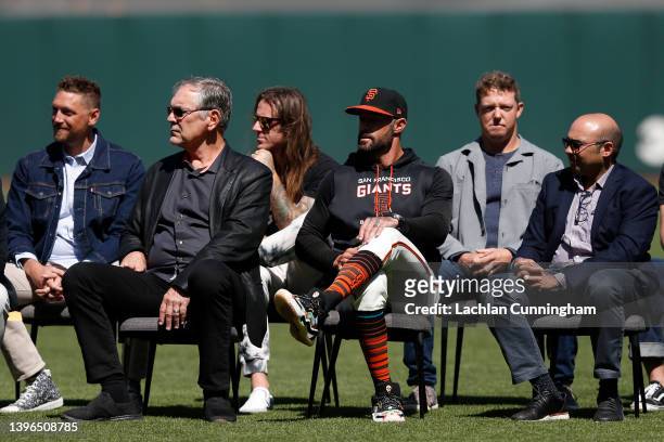 Former San Francisco Giants manager Bruce Bochy sits with current Giants manager Gabe Kapler during a ceremony honoring retired player Buster Posey...