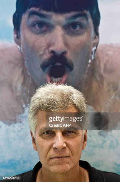 Oly-2008-swim-USA-Spitz by Polly Hui Two-time American Olympic swimmer Mark Spitz poses under a picture of himself during his previous swimming...